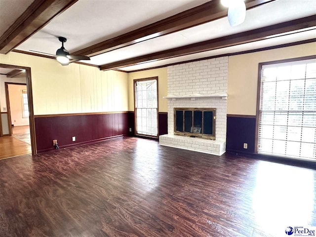 unfurnished living room featuring dark hardwood / wood-style floors and a wealth of natural light