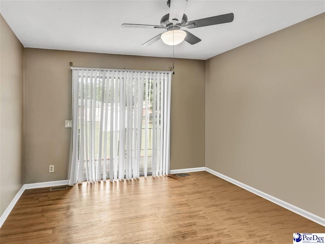 spare room featuring ceiling fan and light hardwood / wood-style flooring