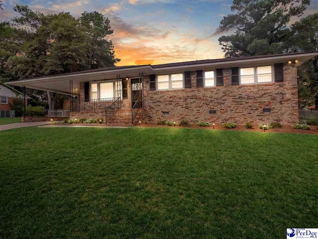 single story home with a carport and a yard