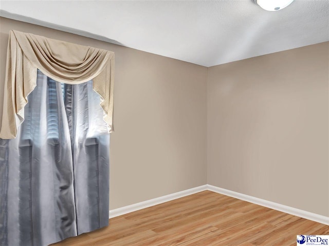 unfurnished room with hardwood / wood-style floors