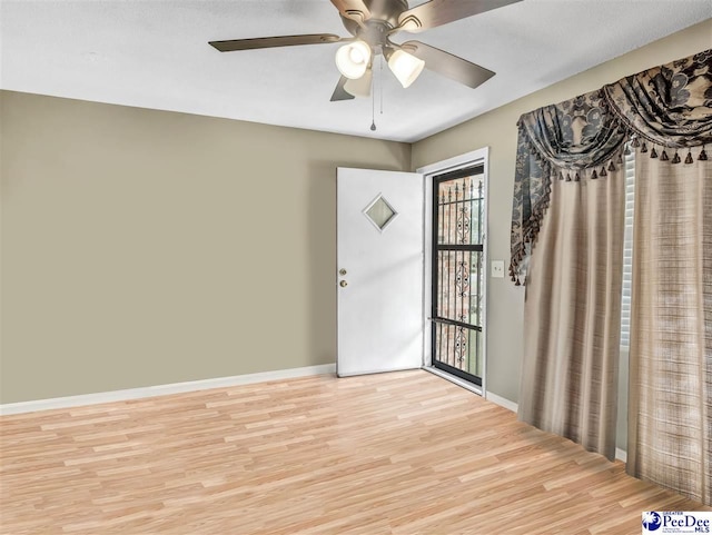 unfurnished room with ceiling fan and light wood-type flooring