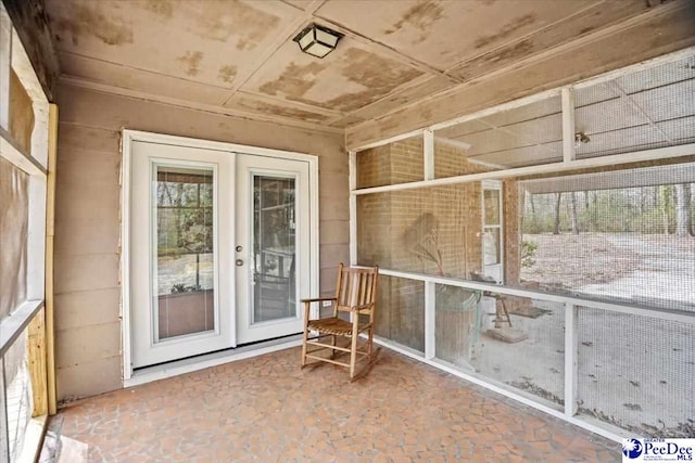 unfurnished sunroom with french doors