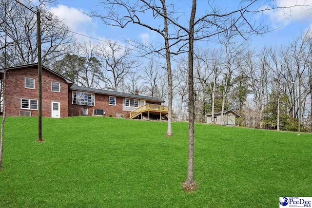 view of yard featuring stairs, a deck, and an outdoor structure