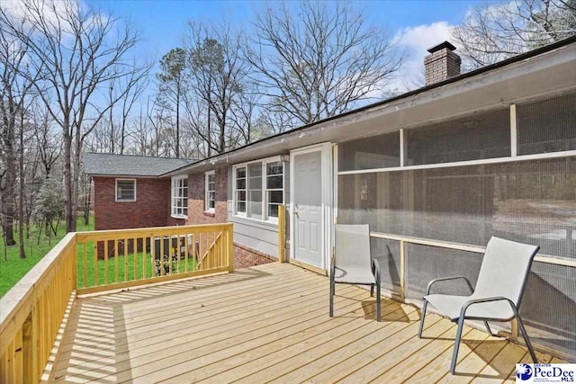 wooden deck featuring a sunroom