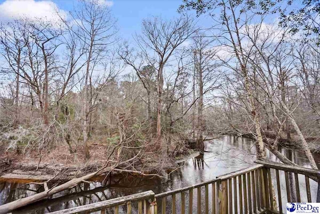 wooden deck with a forest view