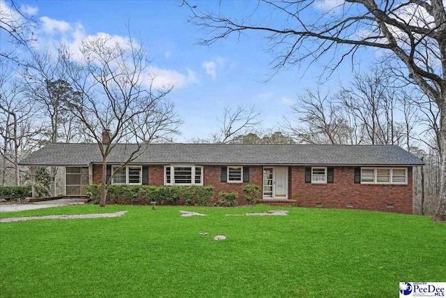 ranch-style house with brick siding, crawl space, a shingled roof, and a front lawn