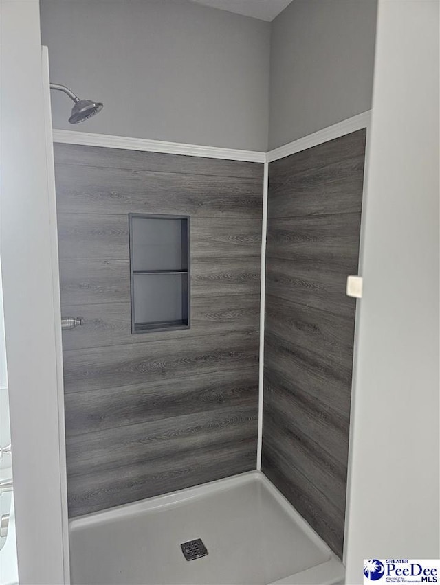 bathroom with tiled shower