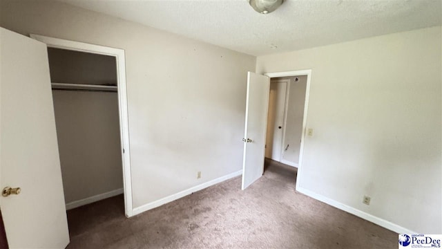 1416 Tradd Ct, Florence, SC 29506 - unfurnished bedroom with carpet flooring, baseboards, a closet, and a textured ceiling