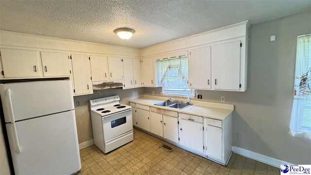 1416 Tradd Ct, Florence, SC 29506 - kitchen with white appliances, under cabinet range hood, a sink, baseboards, and a textured ceiling