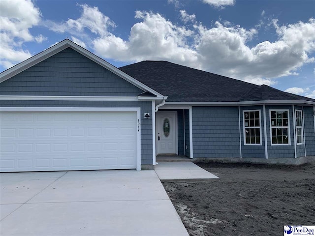 4978 E National Cemetery Rd, Florence, SC 29506 - single story home featuring an attached garage, driveway, and roof with shingles