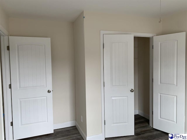 4978 E National Cemetery Rd, Florence, SC 29506 - unfurnished bedroom featuring dark wood-style floors and baseboards