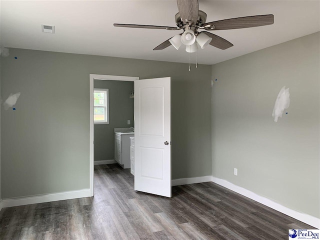 4978 E National Cemetery Rd, Florence, SC 29506 - empty room with dark wood-style floors, ceiling fan, baseboards, and washer / dryer