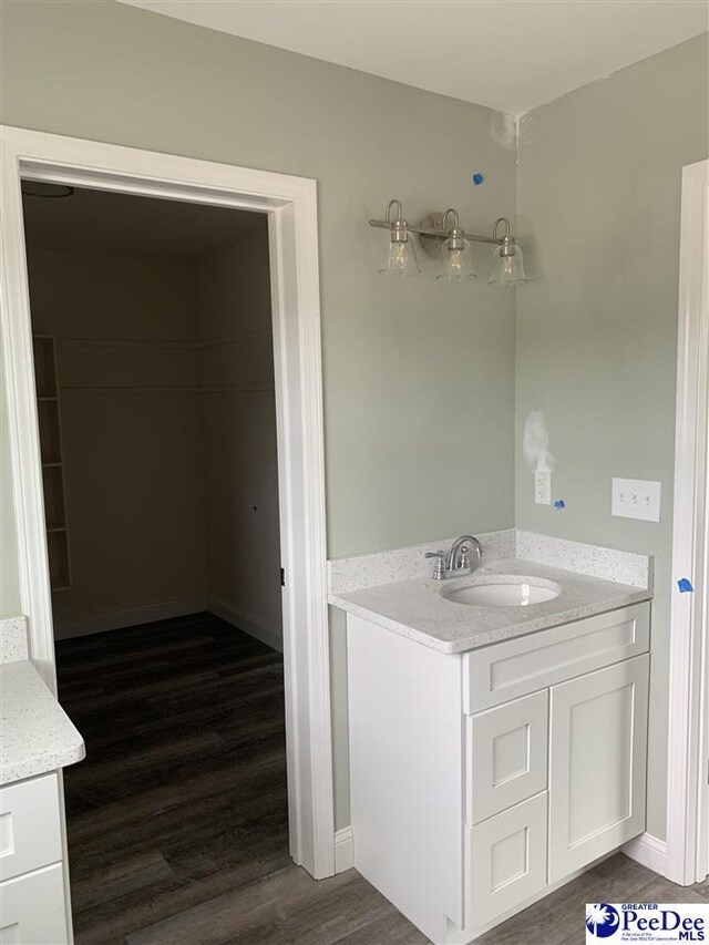 4978 E National Cemetery Rd, Florence, SC 29506 - bathroom with vanity, wood finished floors, and baseboards