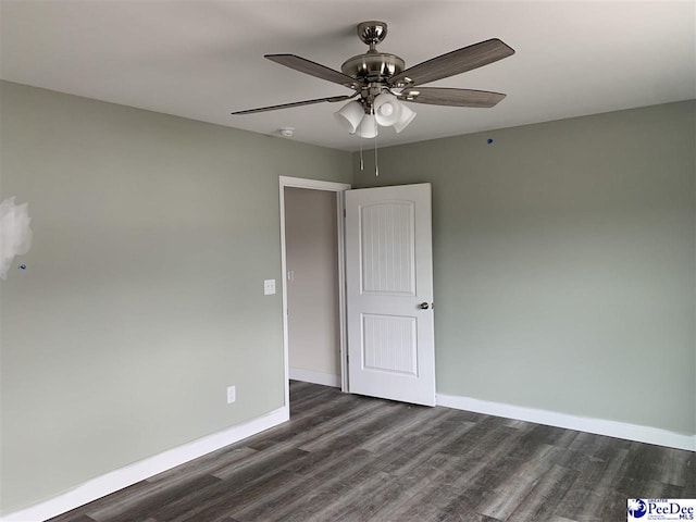 4978 E National Cemetery Rd, Florence, SC 29506 - spare room featuring dark wood-type flooring, baseboards, ceiling fan, and a smoke detector