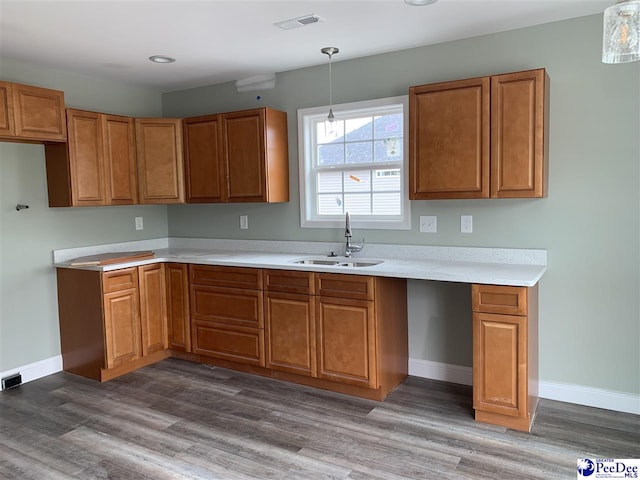 4978 E National Cemetery Rd, Florence, SC 29506 - kitchen with brown cabinets, a sink, dark wood-style floors, and recessed lighting
