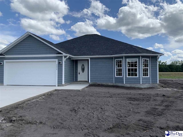 4978 E National Cemetery Rd, Florence, SC 29506 - single story home featuring an attached garage, concrete driveway, and roof with shingles