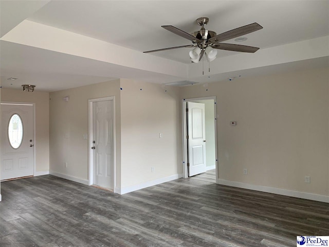 4978 E National Cemetery Rd, Florence, SC 29506 - unfurnished living room with baseboards and dark wood-style flooring