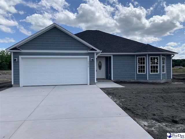 4978 E National Cemetery Rd, Florence, SC 29506 - ranch-style house with driveway, an attached garage, and roof with shingles