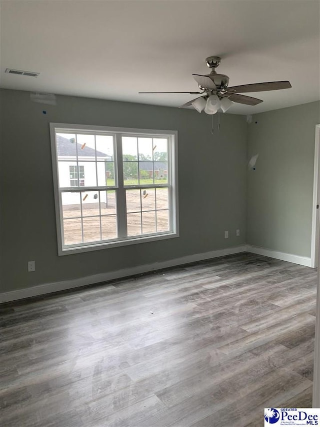 4978 E National Cemetery Rd, Florence, SC 29506 - unfurnished room with ceiling fan, wood finished floors, and baseboards