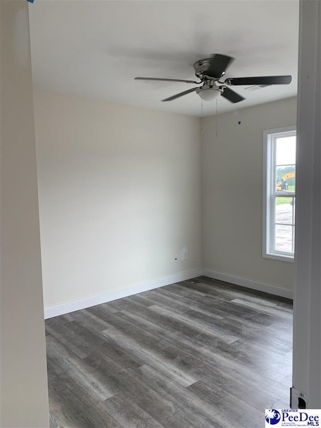4978 E National Cemetery Rd, Florence, SC 29506 - unfurnished room with dark wood-style flooring, ceiling fan, and baseboards