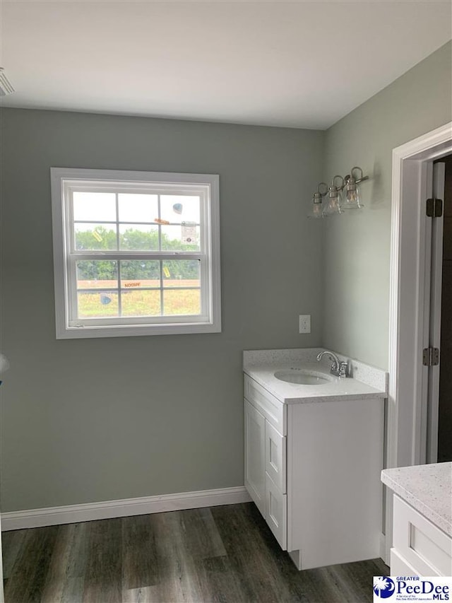 4978 E National Cemetery Rd, Florence, SC 29506 - laundry area featuring a sink, dark wood-type flooring, and baseboards
