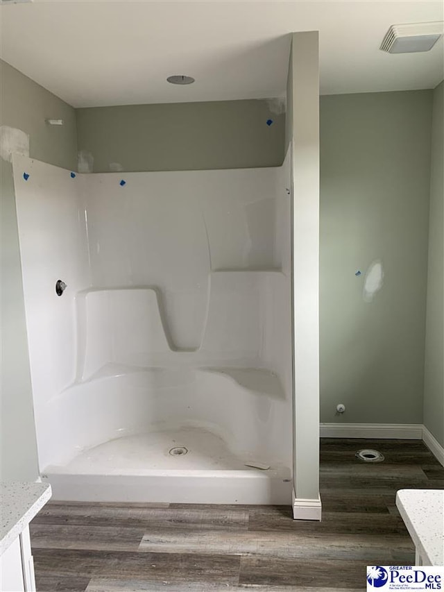 4978 E National Cemetery Rd, Florence, SC 29506 - full bath with vanity, wood finished floors, a shower, and baseboards