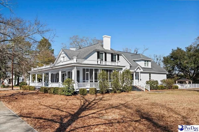 view of front of house featuring a front lawn and a sunroom