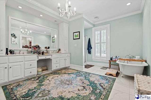 bathroom with baseboards, ornamental molding, vanity, a freestanding tub, and a notable chandelier