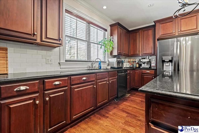 kitchen with tasteful backsplash, stainless steel fridge, ornamental molding, dark wood-type flooring, and a sink