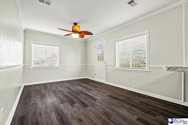 unfurnished room featuring ceiling fan, visible vents, baseboards, dark wood finished floors, and crown molding