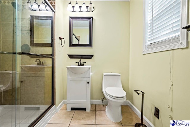 bathroom featuring tile patterned flooring, toilet, vanity, baseboards, and a shower stall