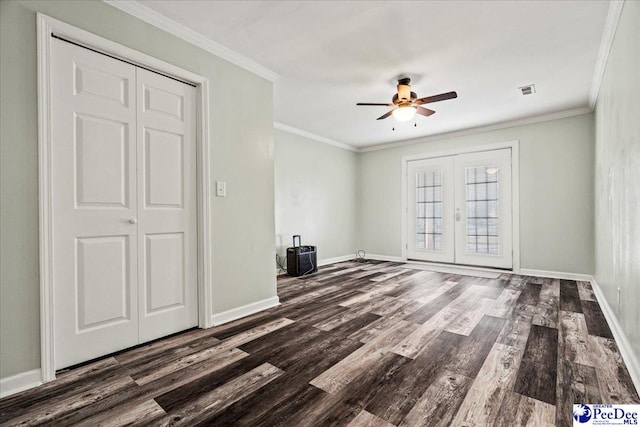 interior space featuring dark wood-style floors, baseboards, ornamental molding, and french doors