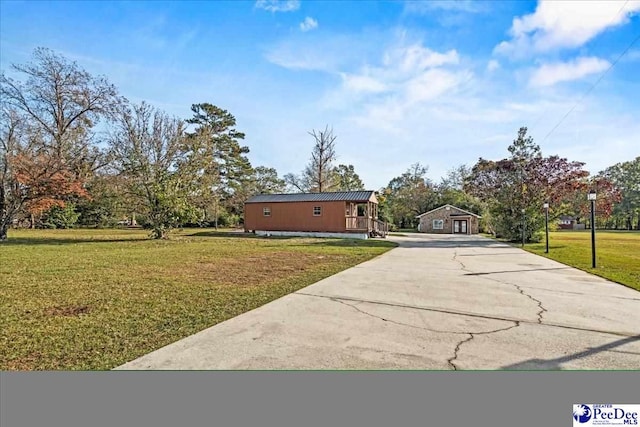 view of front of property featuring concrete driveway and a front yard