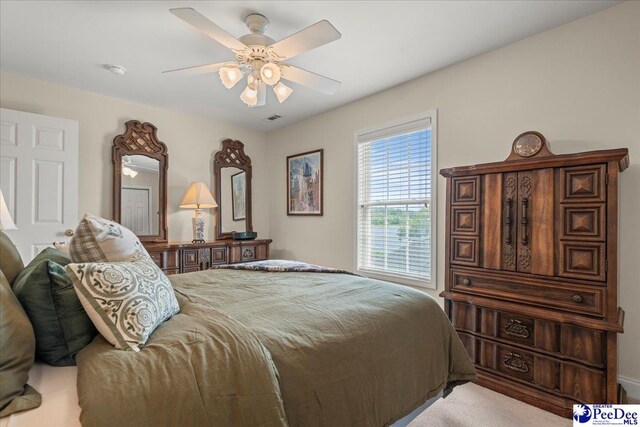 carpeted bedroom with a ceiling fan