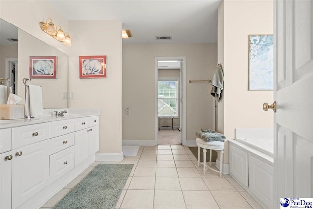 bathroom featuring baseboards, vanity, and tile patterned floors