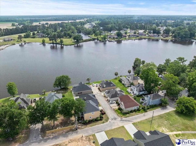 aerial view of residential area featuring a large body of water