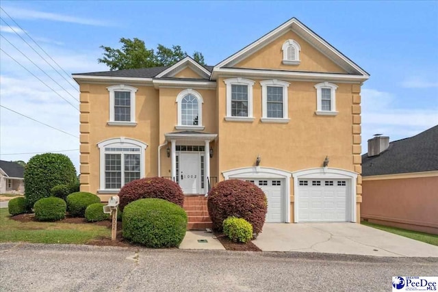 view of front of property with driveway, stucco siding, and an attached garage