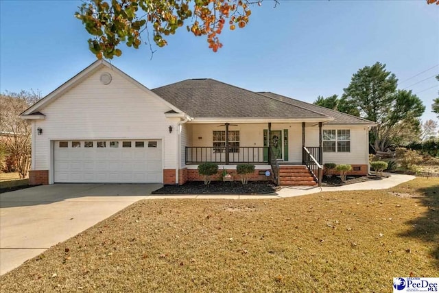 ranch-style home featuring a porch, a garage, and a front yard