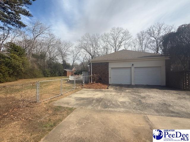 exterior space with driveway and fence