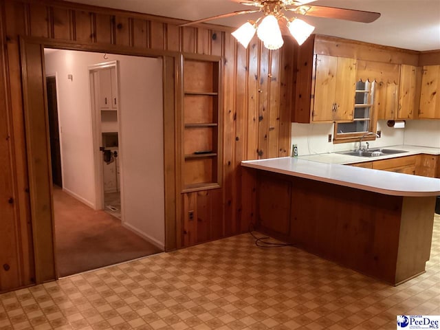 429 S Wallace Rd, Florence, SC 29506 - kitchen featuring sink, kitchen peninsula, ceiling fan, and wood walls