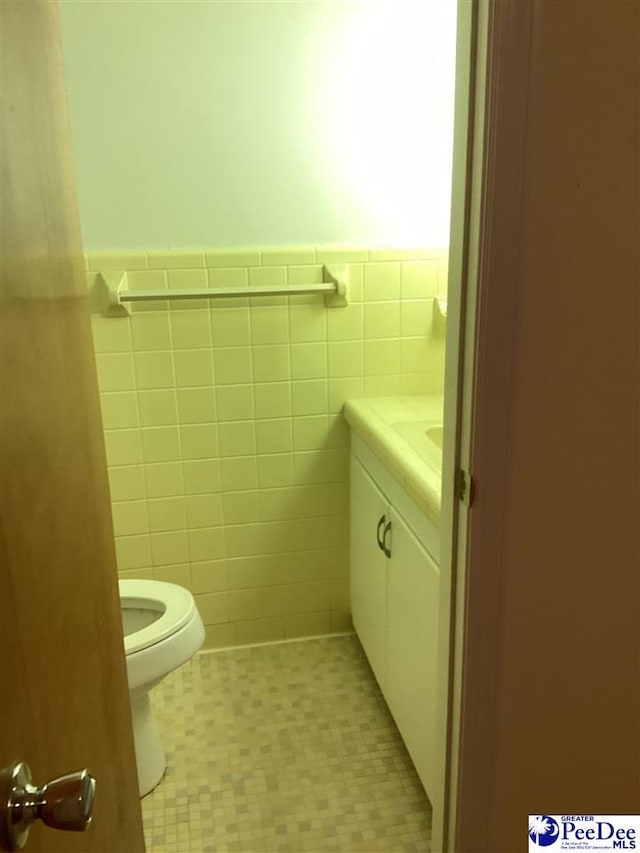 429 S Wallace Rd, Florence, SC 29506 - bathroom featuring vanity, toilet, and tile walls
