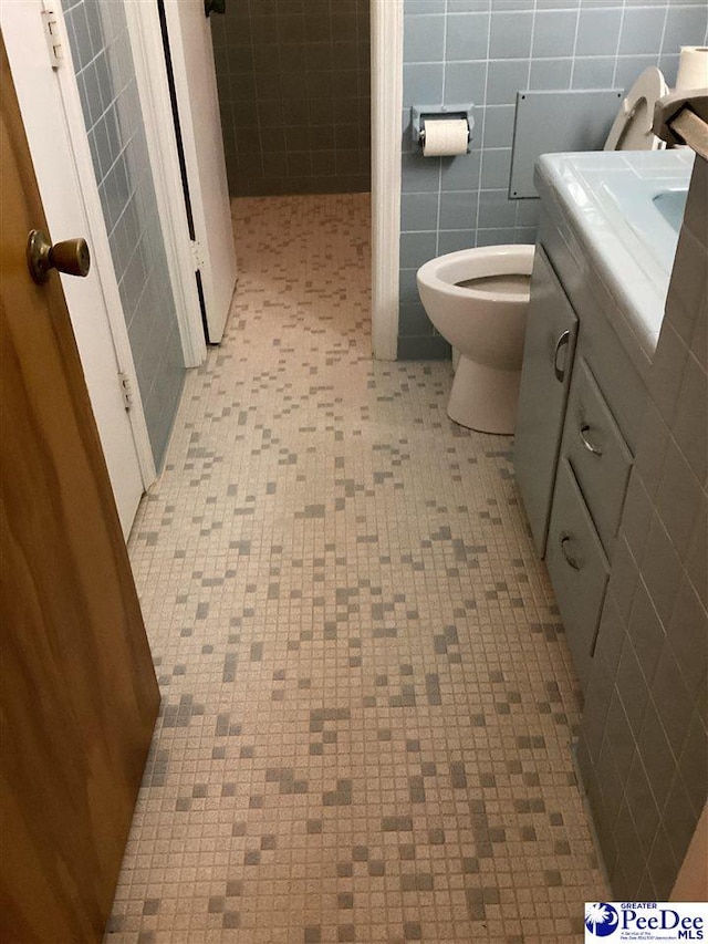 429 S Wallace Rd, Florence, SC 29506 - bathroom featuring vanity, toilet, and tile walls