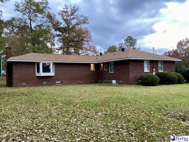 429 S Wallace Rd, Florence, SC 29506 - rear view of house featuring a yard