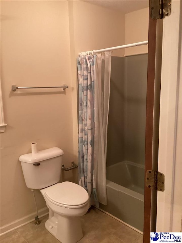429 S Wallace Rd, Florence, SC 29506 - bathroom featuring tile patterned flooring, toilet, and shower / bath combo with shower curtain