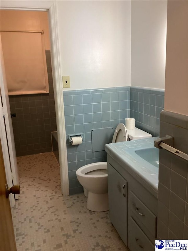 429 S Wallace Rd, Florence, SC 29506 - bathroom featuring vanity, tile walls, and toilet