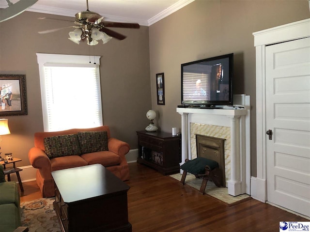 living room featuring crown molding, ceiling fan, and dark hardwood / wood-style flooring