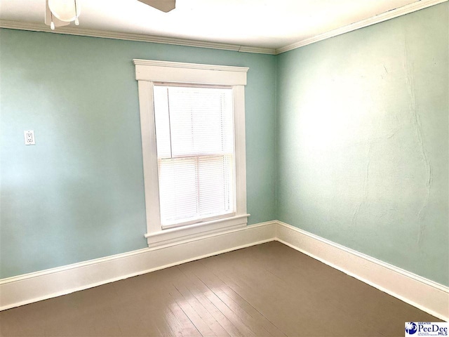 spare room featuring hardwood / wood-style flooring and ornamental molding