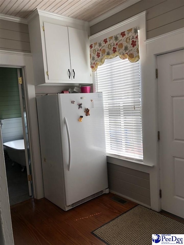 kitchen featuring wood ceiling, crown molding, dark hardwood / wood-style floors, white cabinets, and white fridge