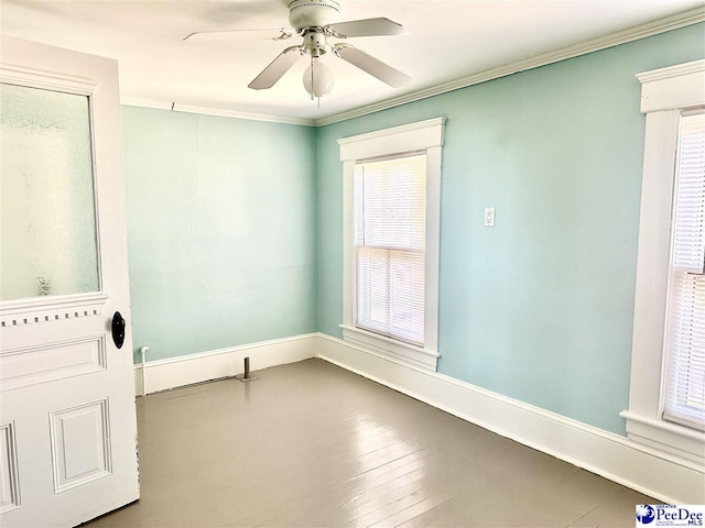 empty room with crown molding, ceiling fan, and wood-type flooring