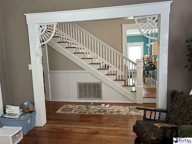 stairs with hardwood / wood-style floors